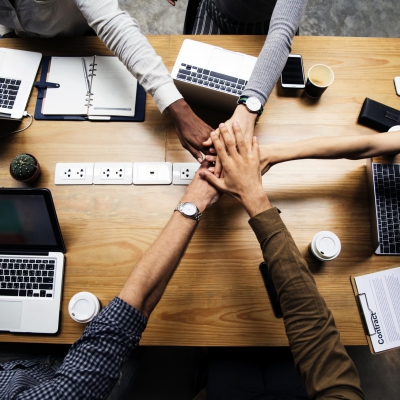 Team of business people stacking hands