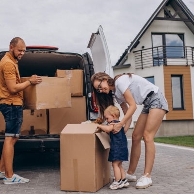 Young family with little daughter moving into new house